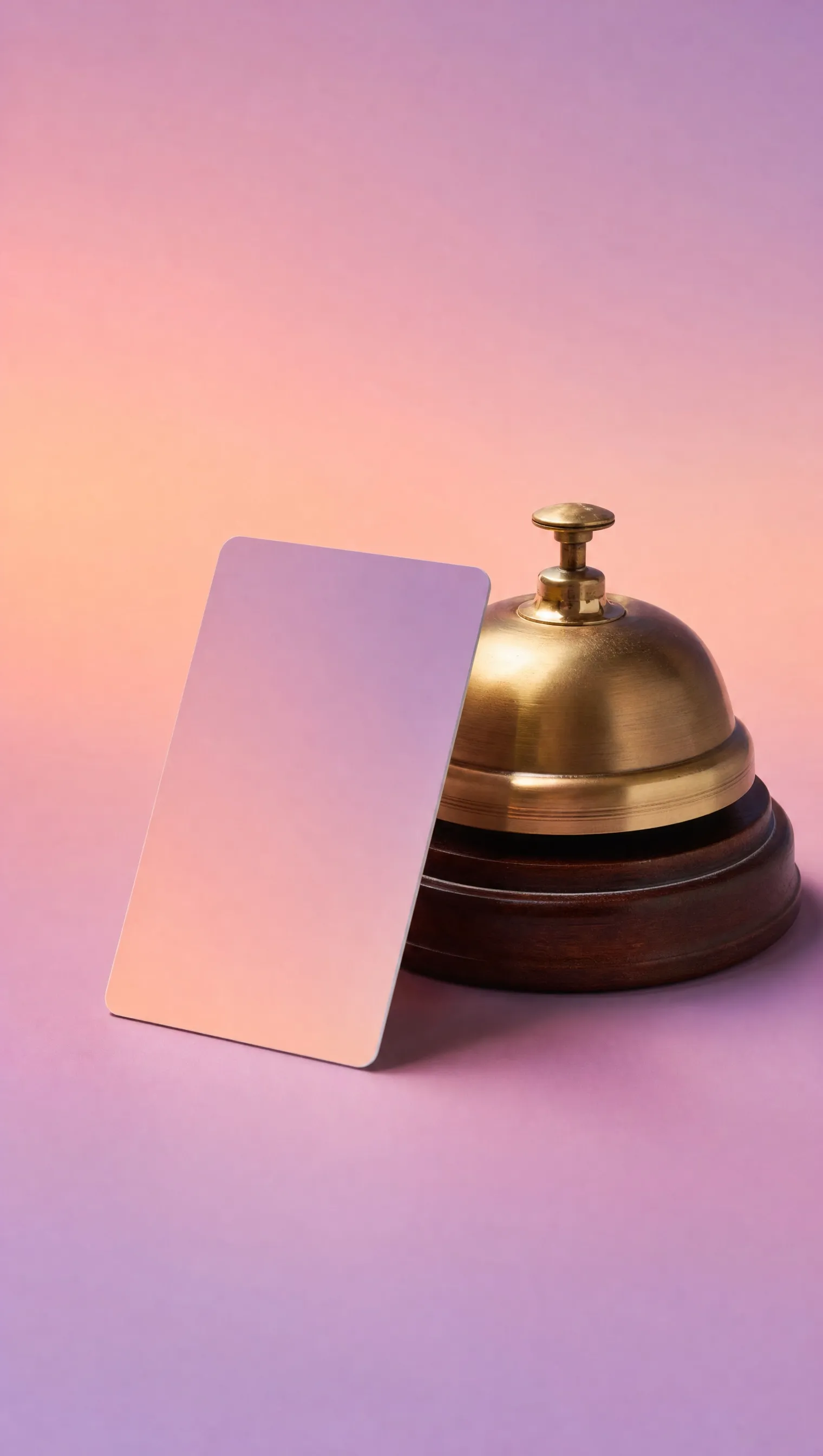 A hotel key card and a brass bell on a plinth