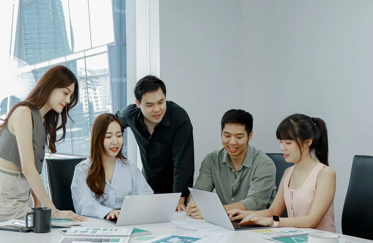 Primal team members around a meeting table with laptops and printouts