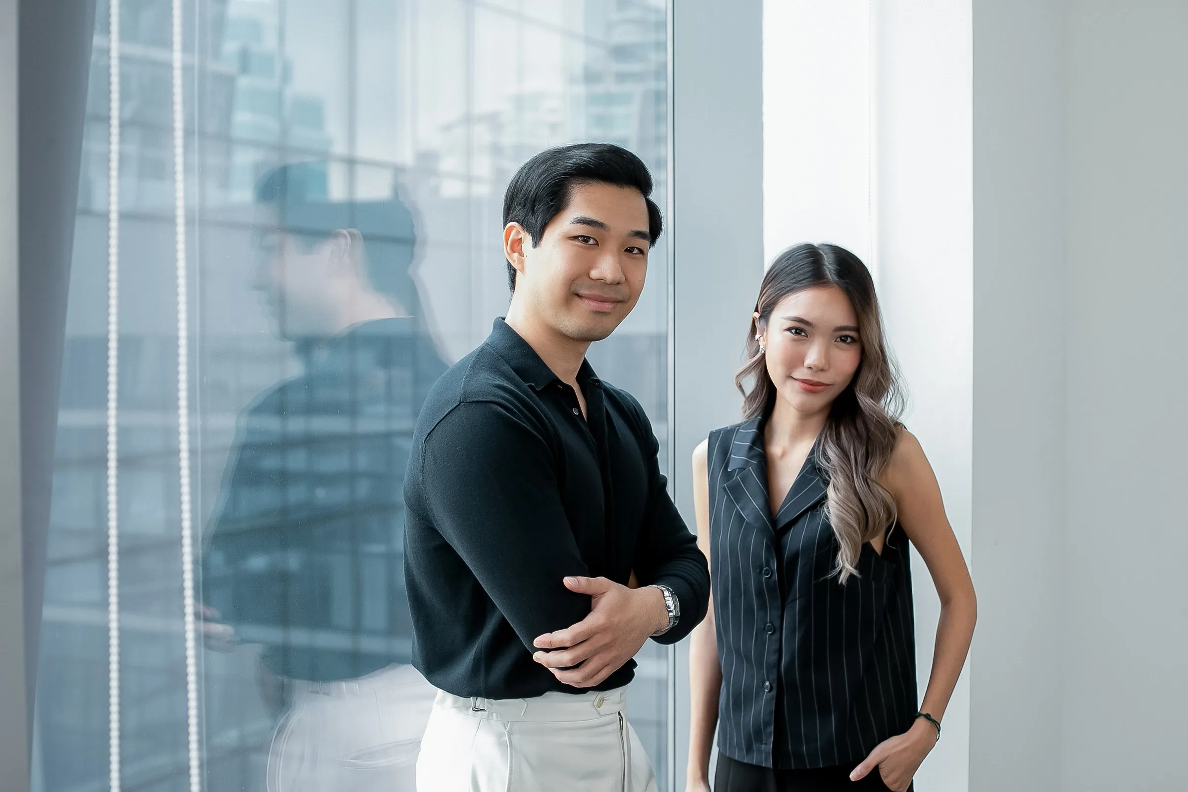 Two Primal colleagues standing by a glass wall in the office