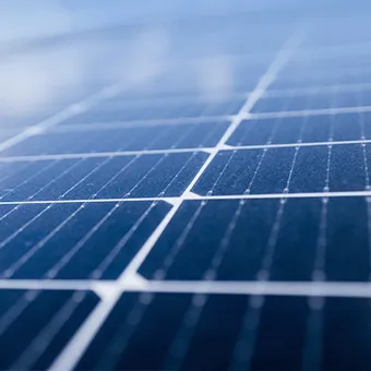 A close view of the cells and white grid lines of a solar panel