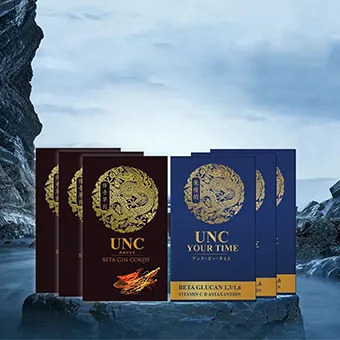 Boxes of UNC Beta Gin Cordy and UNC Your Time on a rock by the sea under a grey sky