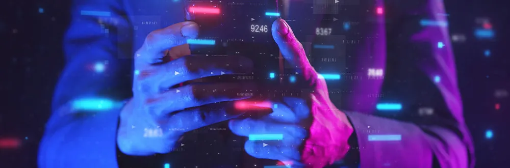 Hands holding a phone among glowing blue and pink lines and numbers on a dark background